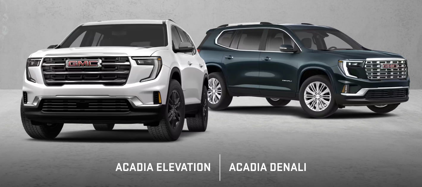 White GMC Acadia Elevation and dark green GMC Acadia Denali shown side by side from front three-quarter angles.